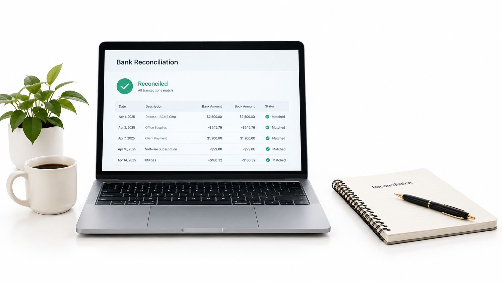 A laptop displaying a bank reconciliation dashboard next to a coffee mug, houseplant, and a spiral notebook.